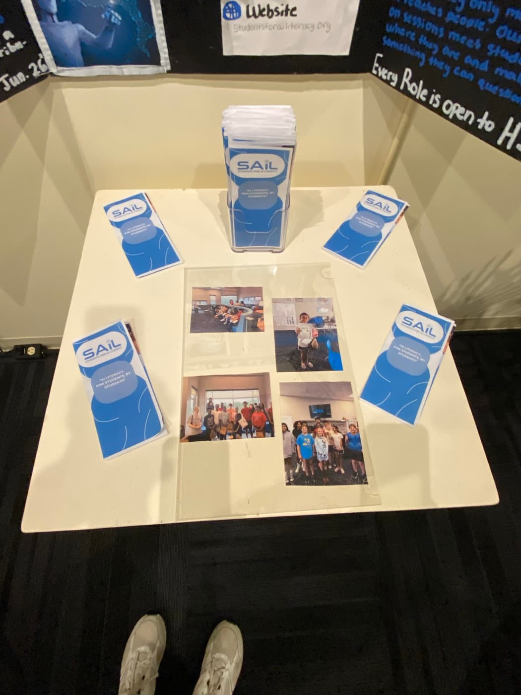 SAIL brochures and a flyer dispenser arranged on the display plinth, reading 'AI literacy for students, by students'