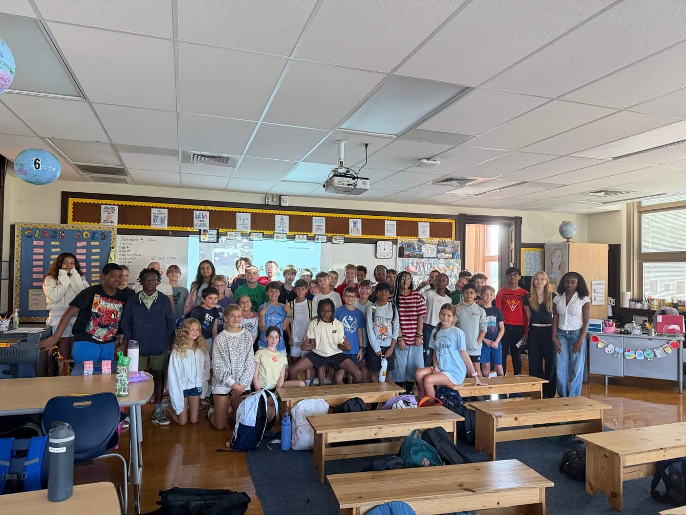 A class of Hyde Park School students gathered for a group photo with SAIL volunteers at the end of their session