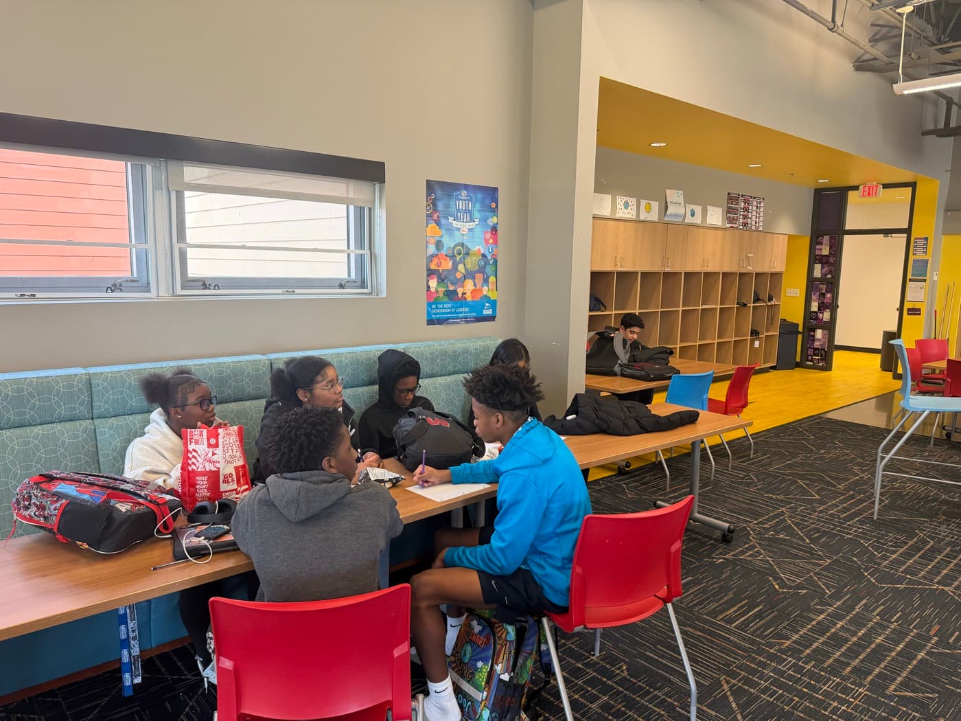 Students working through an activity in small groups at the Boys & Girls Club