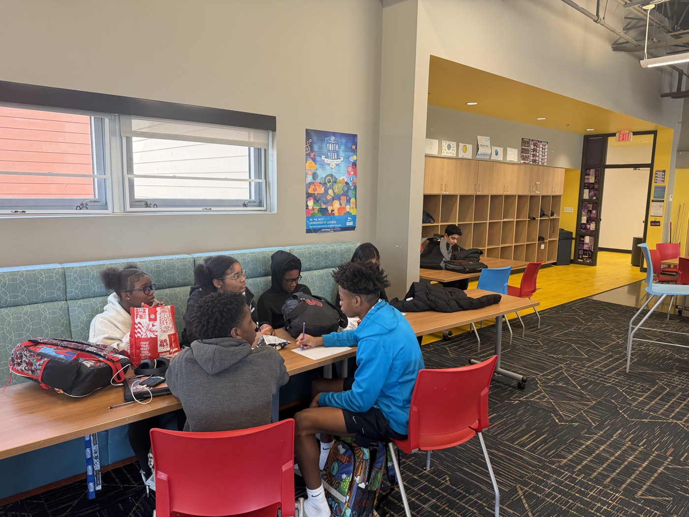 Students working through an activity in small groups at the Boys & Girls Club